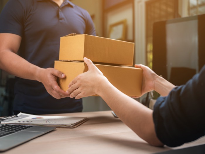 A parcel being handed to its recipient
